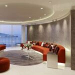 Bright orange long couch and bean bag idea for living room seating