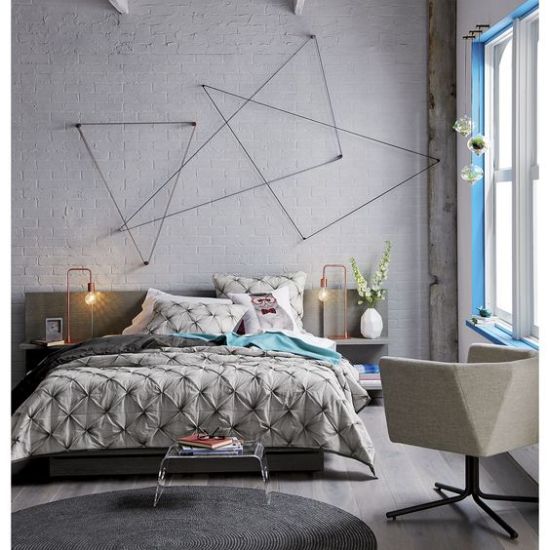 Creative grey accented concrete wall decorated with triangular wall art Concrete Block Walls